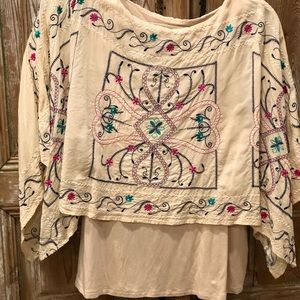 Cream tunic with embroidered pink blue and green. Spandex lining